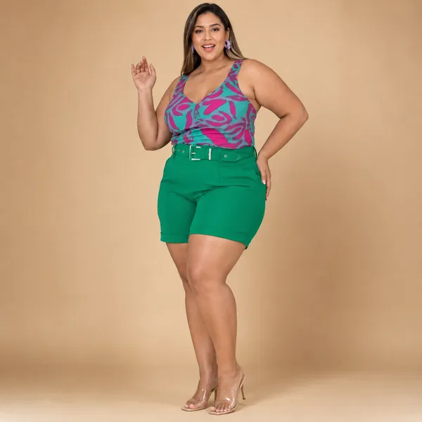 Modelo plus size veste regata estampada rosa e verde com shorts verde de cinto